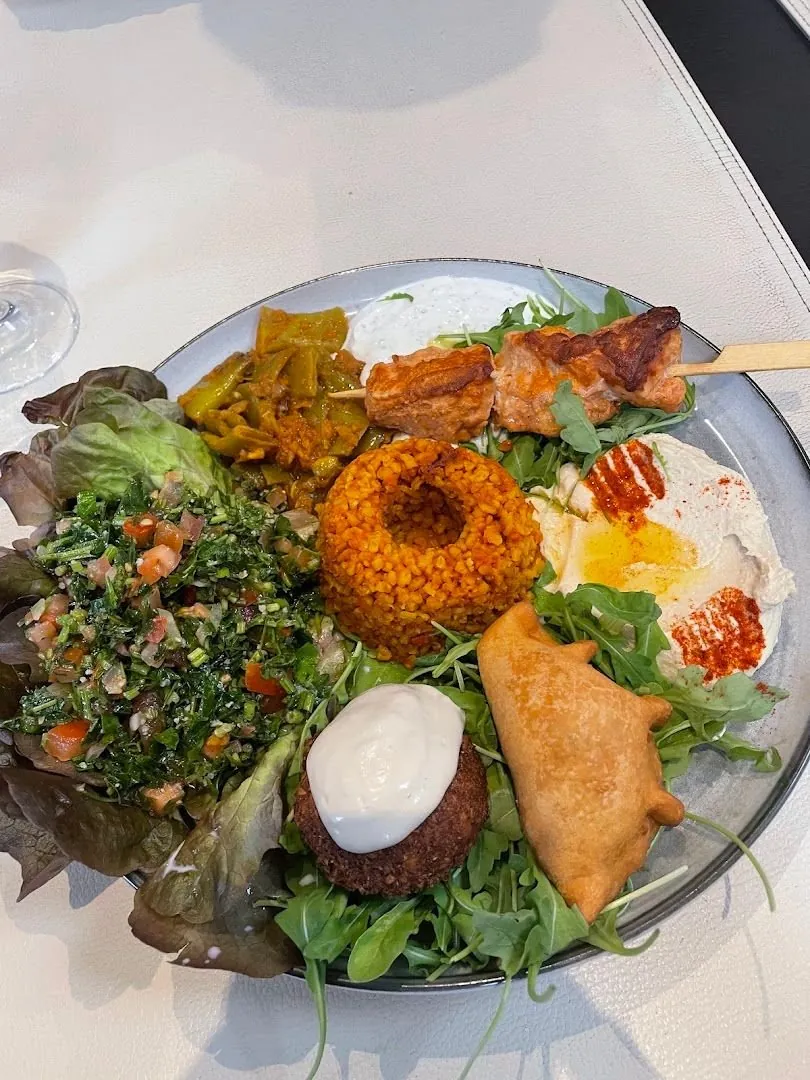 Une assiette libanaise servie sur place : taboulé, houmous, falafel, samboussek, brochette